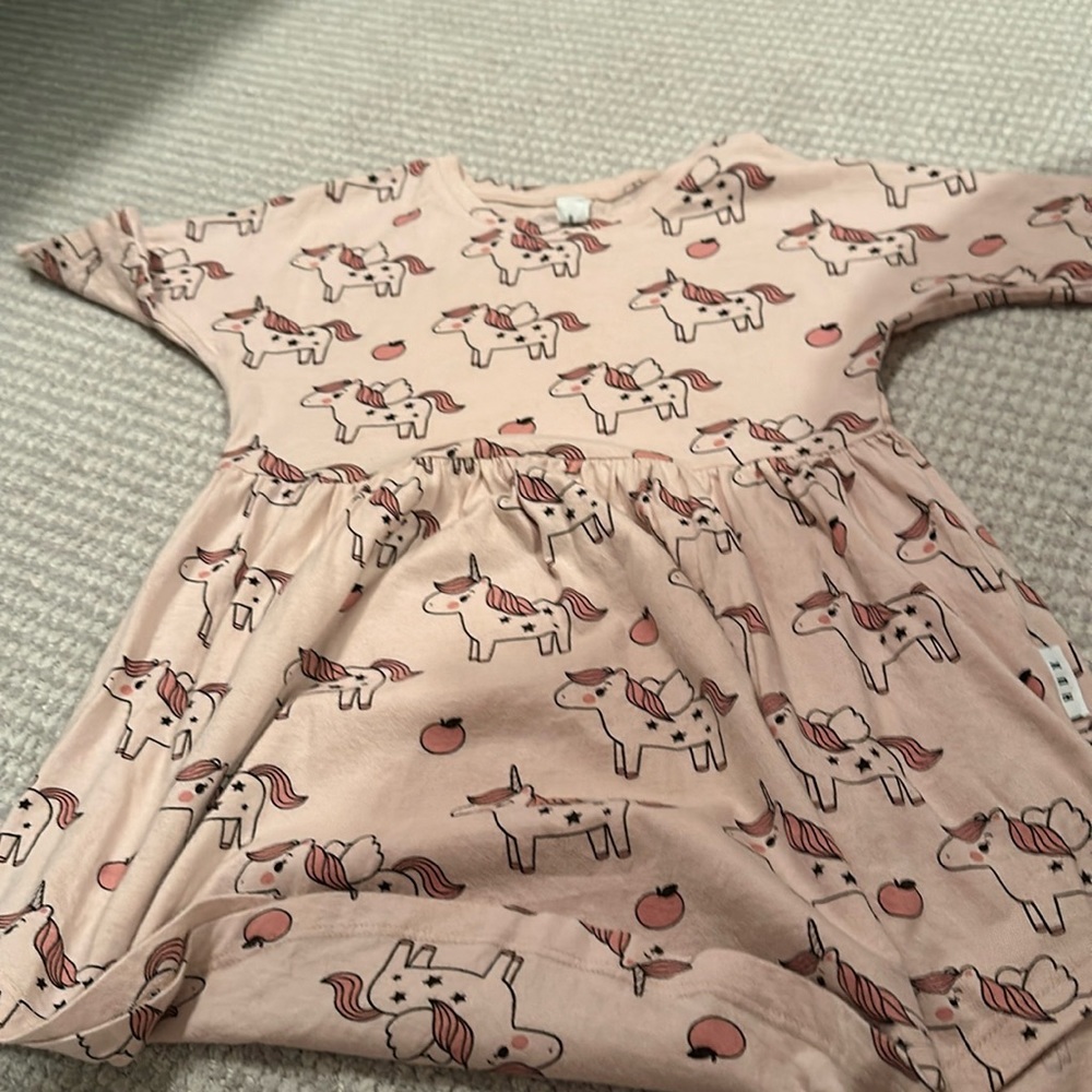 Cute apple, unicorn dress peach color girls under the age of five.